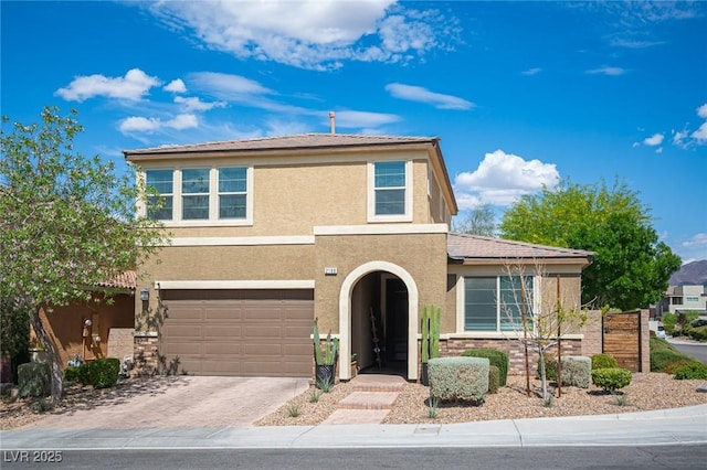 2198 Maderno St, Henderson, NV 89044 - view of front facade with stucco siding, an attached garage, and driveway