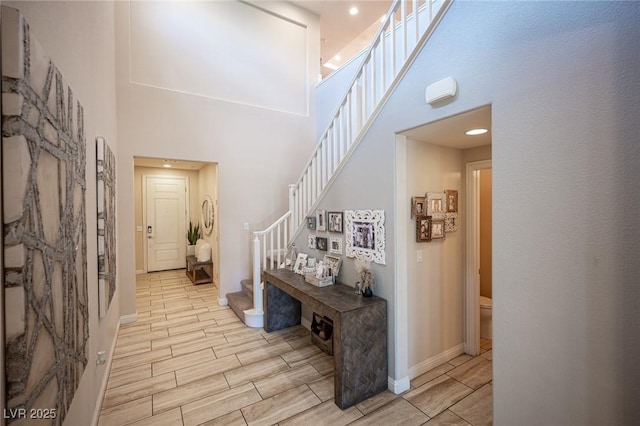 2198 Maderno St, Henderson, NV 89044 - corridor with a towering ceiling, wood finish floors, stairs, baseboards, and recessed lighting