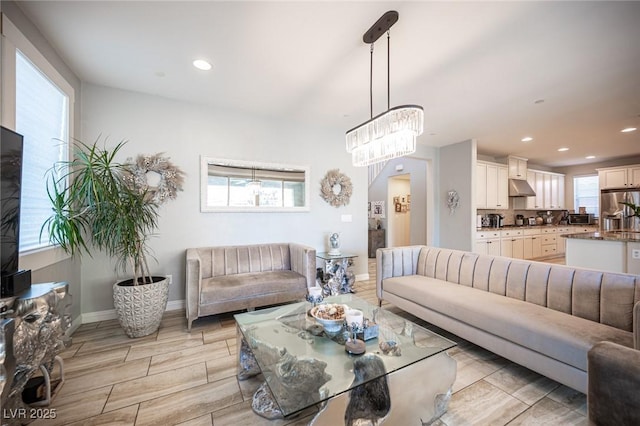 2198 Maderno St, Henderson, NV 89044 - living room featuring recessed lighting, baseboards, a notable chandelier, and wood tiled floor