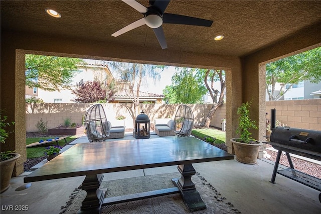2198 Maderno St, Henderson, NV 89044 - view of patio / terrace with grilling area, a ceiling fan, a fenced backyard, and outdoor dining space