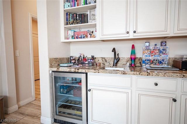 2198 Maderno St, Henderson, NV 89044 - bar with bar, a sink, light wood-style flooring, baseboards, and wine cooler