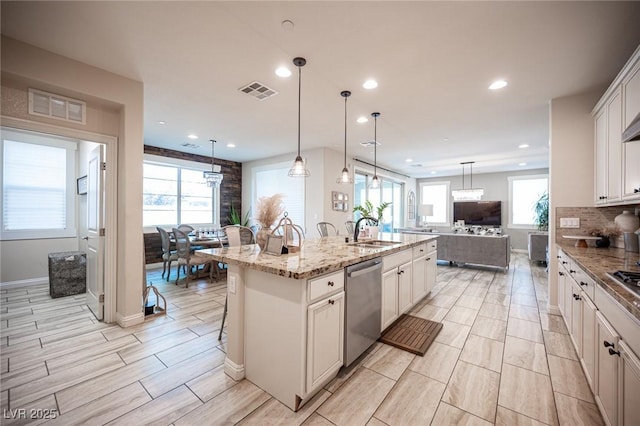 2198 Maderno St, Henderson, NV 89044 - kitchen featuring a sink, a kitchen island with sink, recessed lighting, stainless steel dishwasher, and visible vents