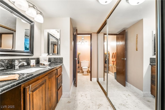 750 S Royal Crest Cir Unit 317, Las Vegas, NV 89169 - bathroom with vanity, toilet, and baseboards