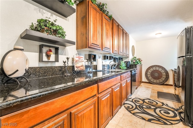 750 S Royal Crest Cir Unit 317, Las Vegas, NV 89169 - kitchen with dishwasher, brown cabinets, dark stone countertops, and freestanding refrigerator
