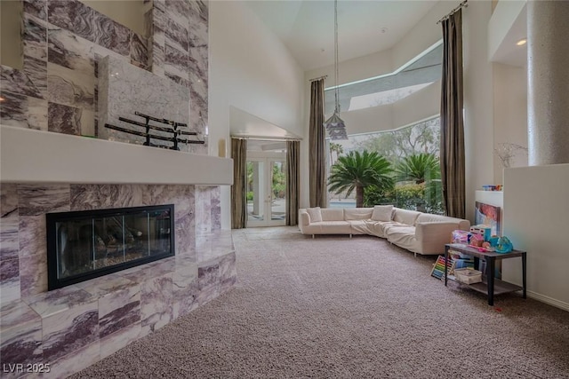 72 Innisbrook Ave, Las Vegas, NV 89113 - carpeted living room with high vaulted ceiling, healthy amount of natural light, and a premium fireplace