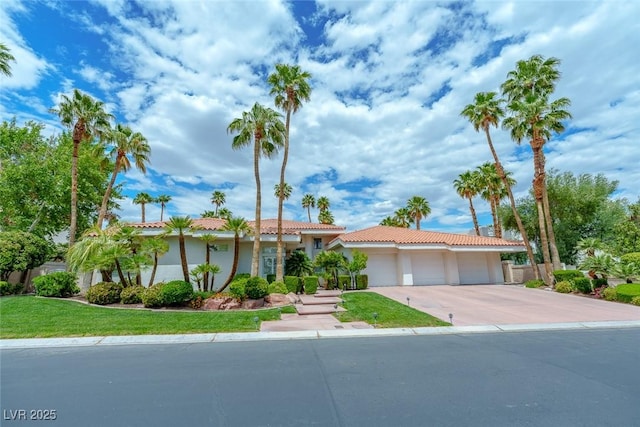 72 Innisbrook Ave, Las Vegas, NV 89113 - ranch-style home featuring an attached garage, driveway, a tile roof, stucco siding, and a front yard