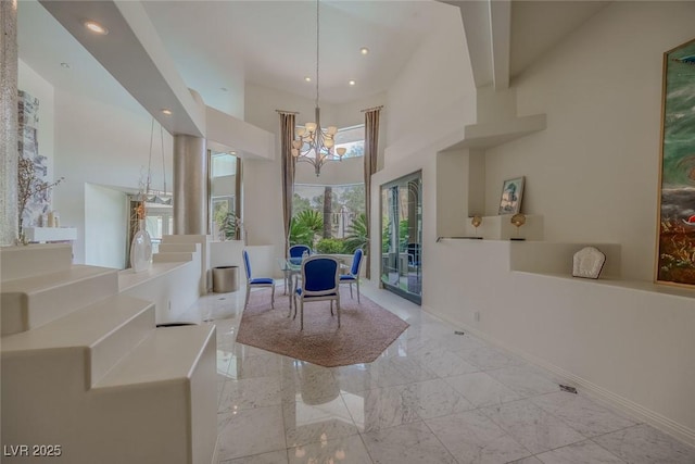 72 Innisbrook Ave, Las Vegas, NV 89113 - dining space with a chandelier, baseboards, light marble finish floors, a towering ceiling, and recessed lighting