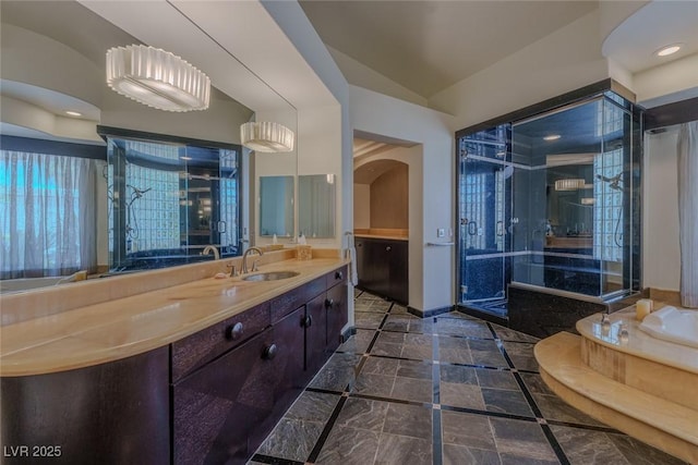 72 Innisbrook Ave, Las Vegas, NV 89113 - full bathroom featuring lofted ceiling, vanity, baseboards, a bath, and a shower with door