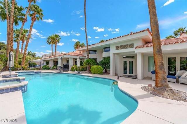 72 Innisbrook Ave, Las Vegas, NV 89113 - view of swimming pool featuring french doors, a patio, and a pool with connected hot tub