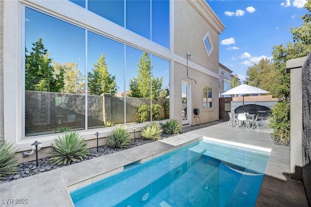 view of swimming pool featuring fence, a fenced in pool, a patio, and outdoor dining area