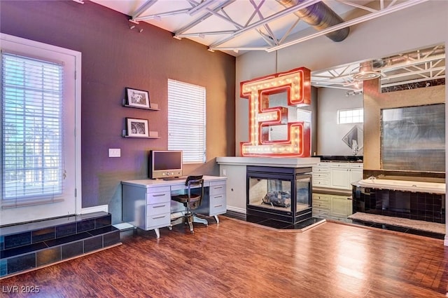 office area featuring a fireplace and dark wood-style flooring