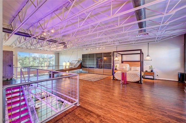 recreation room featuring baseboards and wood finished floors