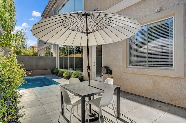 view of patio / terrace with a fenced backyard, a fenced in pool, and outdoor dining space