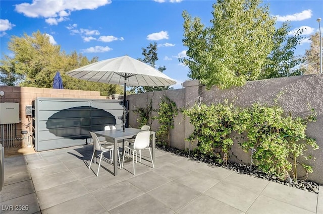 view of patio with outdoor dining area and a fenced backyard