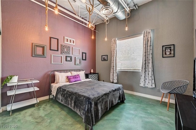 carpeted bedroom featuring baseboards and a high ceiling