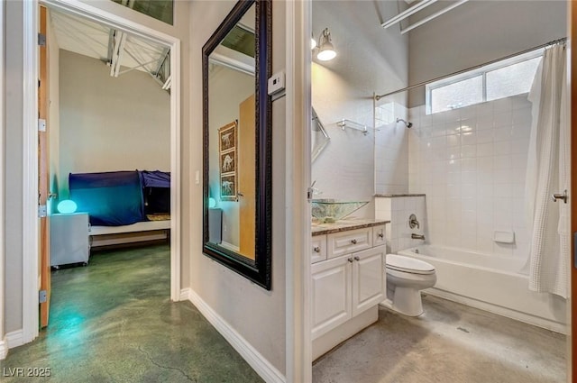 bathroom with concrete flooring, vanity, toilet, shower / bath combo with shower curtain, and ensuite bathroom