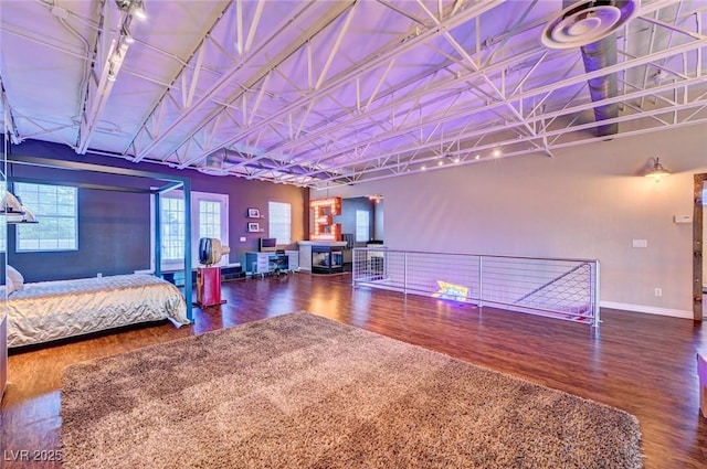 bedroom featuring baseboards and wood finished floors