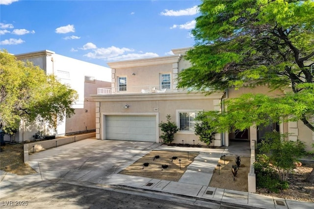 view of front of house featuring an attached garage, stucco siding, concrete driveway, and a balcony