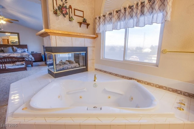 5180 N Dapple Gray Rd, Las Vegas, NV 89149 - full bathroom featuring a fireplace, lofted ceiling, ceiling fan, and a whirlpool tub
