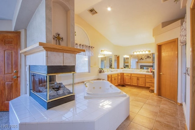 5180 N Dapple Gray Rd, Las Vegas, NV 89149 - full bathroom featuring lofted ceiling, a whirlpool tub, vanity, and tile patterned flooring