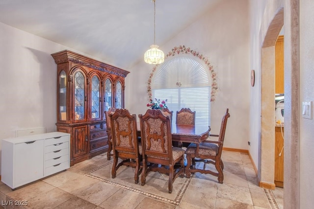 5180 N Dapple Gray Rd, Las Vegas, NV 89149 - dining space with arched walkways, vaulted ceiling, a chandelier, and baseboards