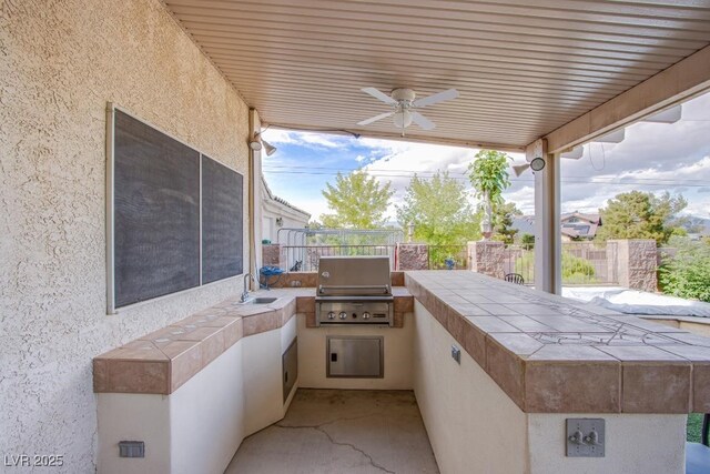 5180 N Dapple Gray Rd, Las Vegas, NV 89149 - view of patio with a grill, an outdoor kitchen, a sink, a ceiling fan, and fence