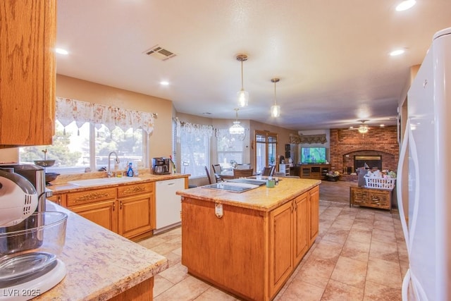 5180 N Dapple Gray Rd, Las Vegas, NV 89149 - kitchen featuring white appliances, a kitchen island, open floor plan, a fireplace, and a ceiling fan