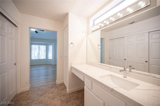 bathroom featuring baseboards, vanity, tile patterned floors, and visible vents