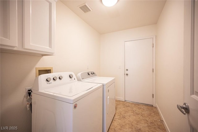 laundry area featuring visible vents, washing machine and dryer, baseboards, cabinet space, and light tile patterned floors