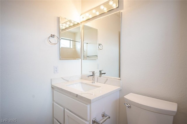 half bathroom with vanity and toilet