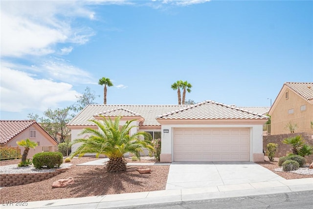 mediterranean / spanish house with stucco siding, an attached garage, driveway, and a tile roof