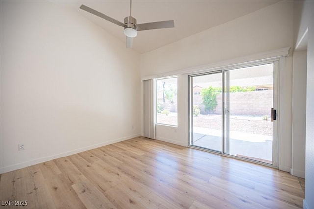spare room featuring light wood-style floors, high vaulted ceiling, baseboards, and a ceiling fan