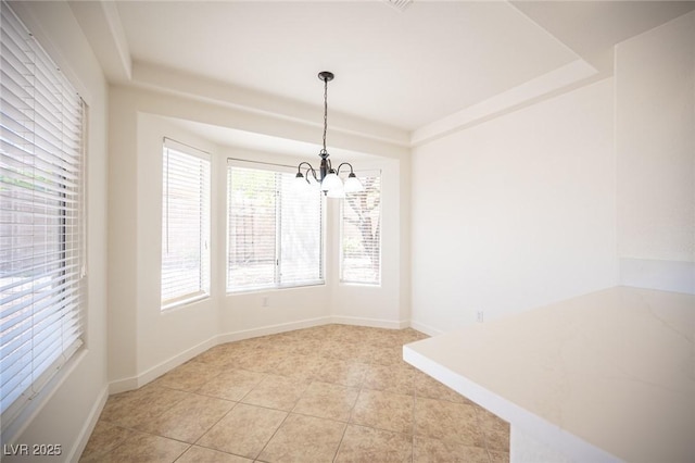 unfurnished dining area with baseboards, plenty of natural light, light tile patterned flooring, and a chandelier