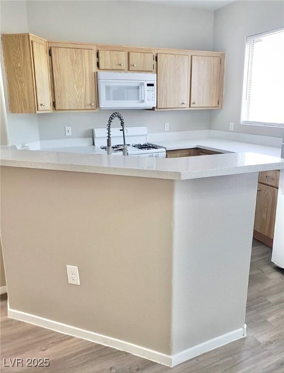 1881 W Alexander Rd Unit 1128, North Las Vegas, NV 89032 - kitchen featuring white appliances, light brown cabinetry, and light countertops