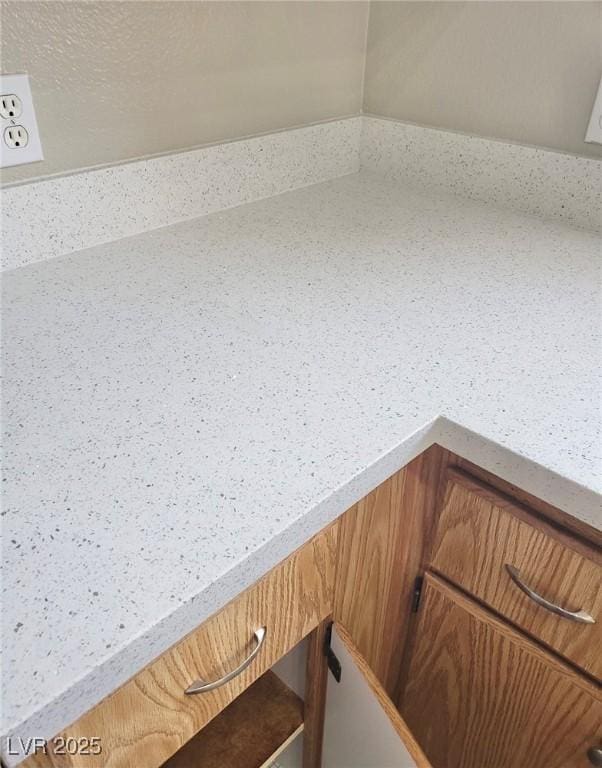 1881 W Alexander Rd Unit 1128, North Las Vegas, NV 89032 - kitchen view of brown cabinetry and light countertops