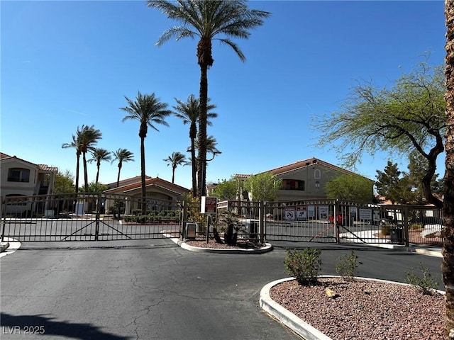 1881 W Alexander Rd Unit 1128, North Las Vegas, NV 89032 - view of asphalt road featuring a gate, a gated entry, and curbs