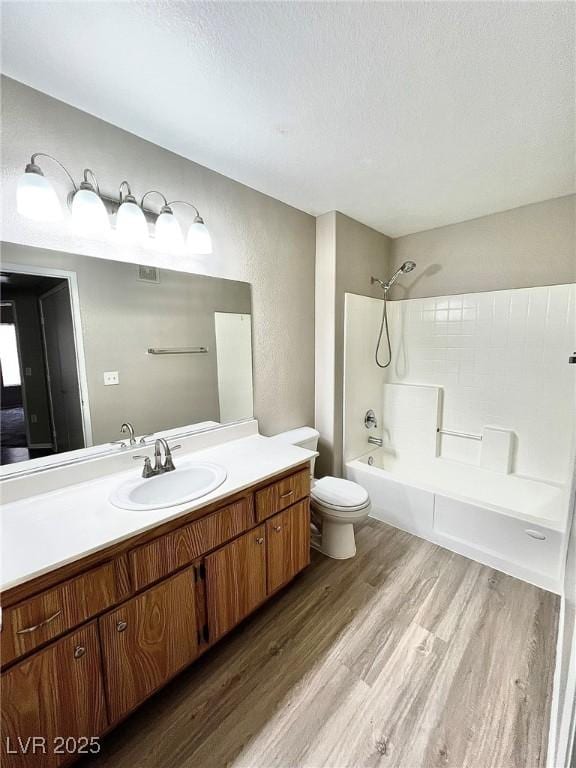 1881 W Alexander Rd Unit 1128, North Las Vegas, NV 89032 - full bathroom with wood finished floors, vanity, tub / shower combination, a textured ceiling, and a textured wall