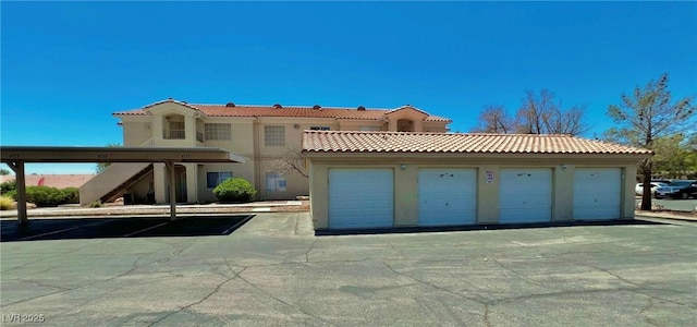1881 W Alexander Rd Unit 1128, North Las Vegas, NV 89032 - mediterranean / spanish house with a tile roof, stucco siding, and community garages