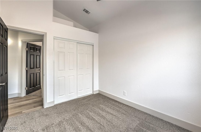 7413 Red Eagle St, Las Vegas, NV 89131 - unfurnished bedroom with vaulted ceiling, carpet floors, a closet, and baseboards