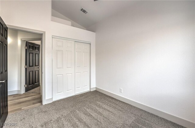 7413 Red Eagle St, Las Vegas, NV 89131 - unfurnished bedroom with vaulted ceiling, carpet floors, a closet, and baseboards