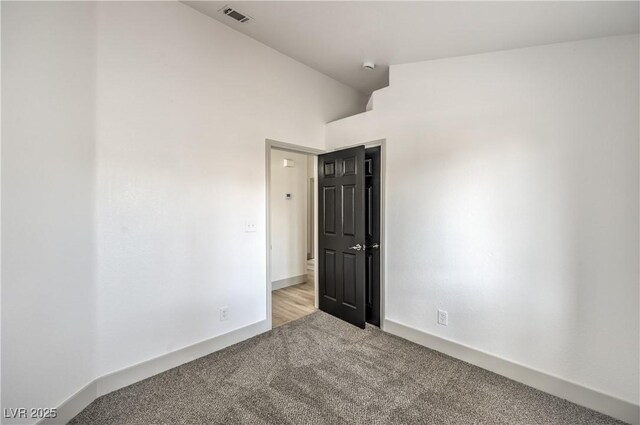 7413 Red Eagle St, Las Vegas, NV 89131 - unfurnished room featuring carpet flooring, baseboards, lofted ceiling, and a smoke detector