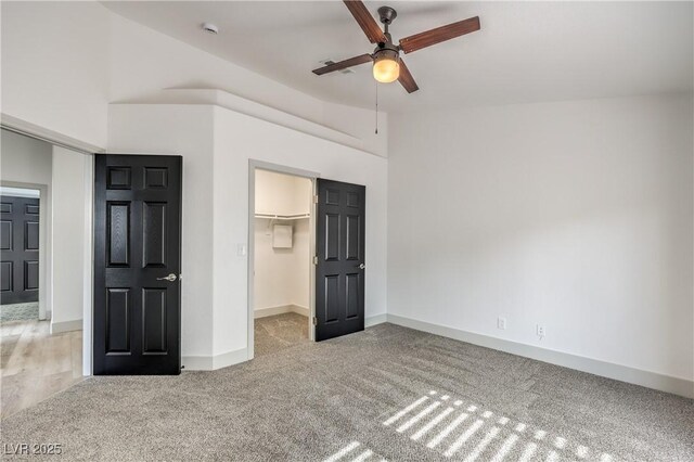7413 Red Eagle St, Las Vegas, NV 89131 - unfurnished bedroom featuring light colored carpet, a spacious closet, a closet, baseboards, and a ceiling fan