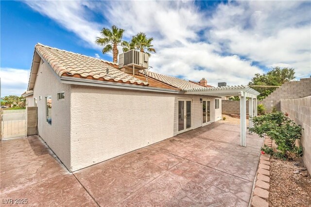 7413 Red Eagle St, Las Vegas, NV 89131 - rear view of property featuring stucco siding, central AC, a pergola, and a tiled roof