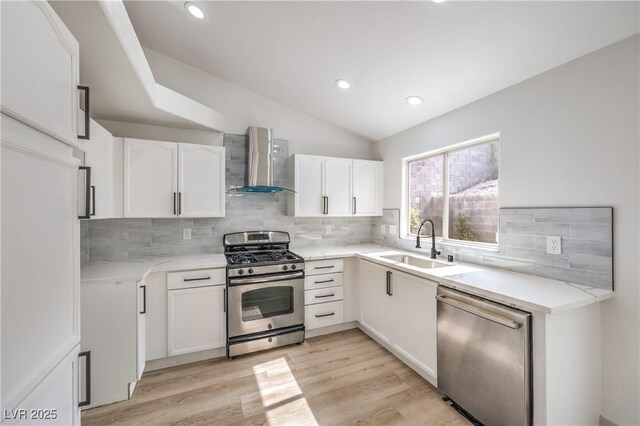 7413 Red Eagle St, Las Vegas, NV 89131 - kitchen with wall chimney exhaust hood, stainless steel appliances, a sink, backsplash, and white cabinetry