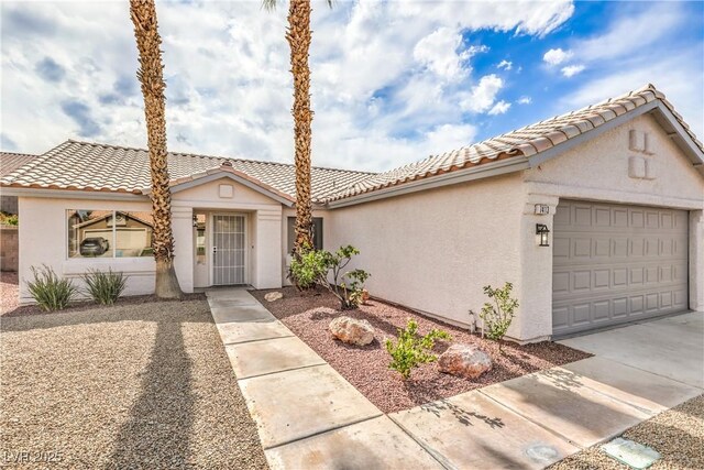 7413 Red Eagle St, Las Vegas, NV 89131 - mediterranean / spanish home featuring a garage, stucco siding, driveway, and a tiled roof