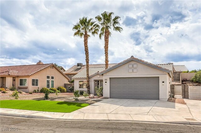 7413 Red Eagle St, Las Vegas, NV 89131 - mediterranean / spanish-style house featuring concrete driveway, stucco siding, an attached garage, and a tile roof