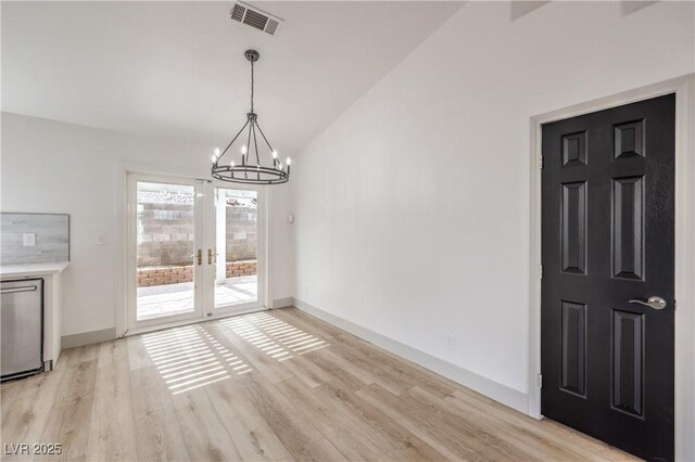 7413 Red Eagle St, Las Vegas, NV 89131 - unfurnished dining area with a chandelier, light wood-style flooring, vaulted ceiling, french doors, and baseboards