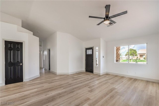 7413 Red Eagle St, Las Vegas, NV 89131 - unfurnished living room featuring vaulted ceiling, light wood-style floors, a ceiling fan, and baseboards