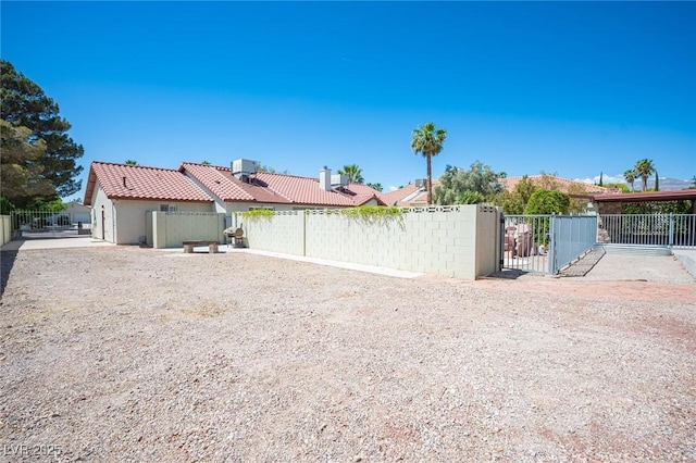 exterior space with fence, a gate, and central AC