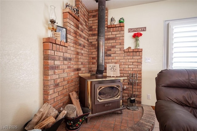 living room with brick floor and a wood stove
